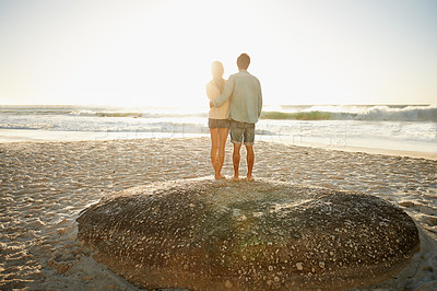 Buy stock photo Sunrise, beach and back of couple in nature with hug, support and romance while bonding with love. Summer, travel and people embrace at sunset with ocean view mockup, space or vacation in Florida