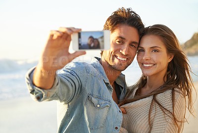 Buy stock photo Couple, selfie and hug with smile at beach for memory on vacation with care, love and bonding in summer. Man, woman and tropical holiday with photography, profile picture and post on social network