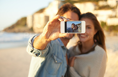 Buy stock photo Couple, selfie and smile for phone screen by ocean for memory on vacation with care, love and tropical beach. Man, woman and hug with photography, profile picture or mobile app by sea on social media