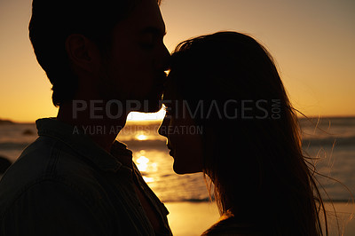 Buy stock photo Couple, beach and sunset or silhouette love on vacation for coast holiday, connection or bonding. Man, woman and hug embrace at sea ocean for summer travel or evening journey, explore or together