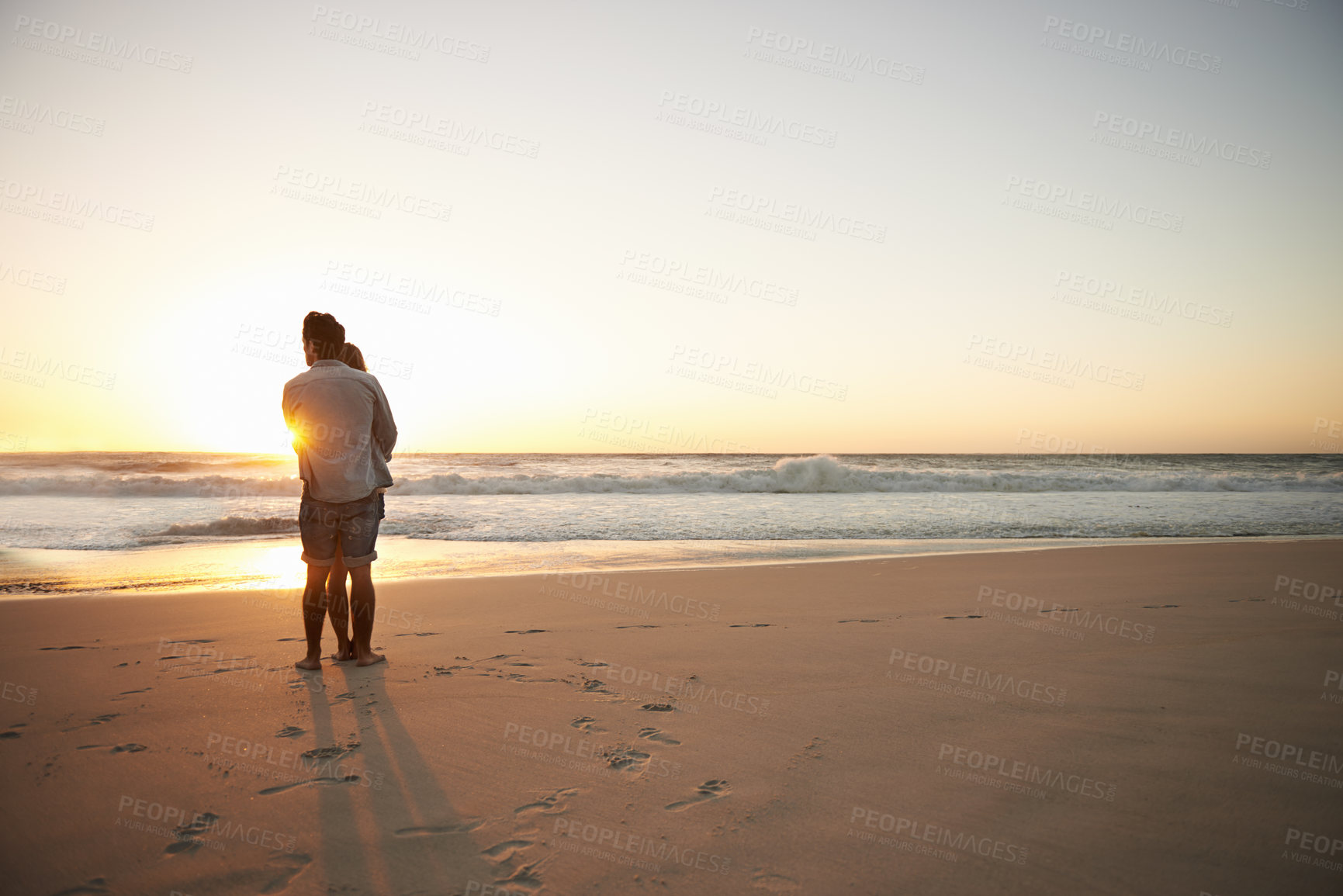Buy stock photo Couple, hug and beach sunset for summer travel or adventure, bonding or marriage. People, love and embrace at ocean water for dating tourism or back view for nature vacation, mockup or holiday