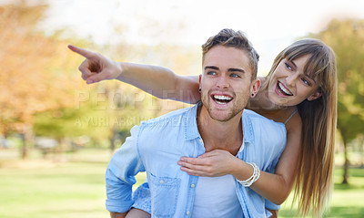 Buy stock photo Piggy back, pointing and couple in a park, love and romance with happiness and relationship. Man carrying woman, outdoor and marriage with joy and bonding together with nature and summer break