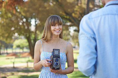 Buy stock photo Couple, park or happy woman with vintage camera for outdoor photography, photo memory or tourism. Retro equipment, creative photoshoot or photographer shooting  boyfriend for garden picture in nature