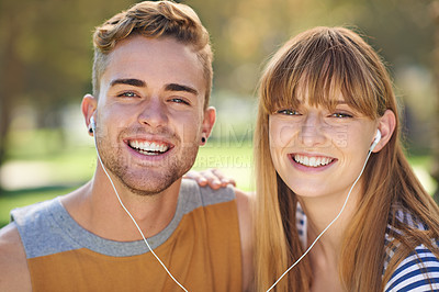 Buy stock photo Couple, smile in portrait and earphones outdoor for music and entertainment, technology and romantic date in park. People listening to radio, podcast or streaming online with happiness in nature
