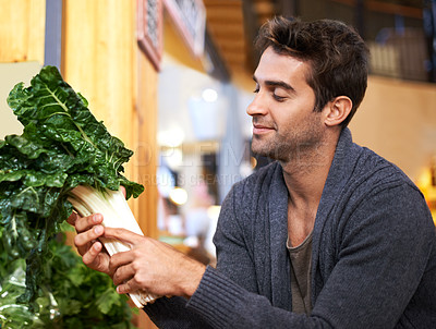 Buy stock photo Spinach, choice and man shopping at a supermarket for grocery promotions, sale or discounts deal. Green plants, fresh or customer buying groceries for healthy nutrition, organic vegetables or diet