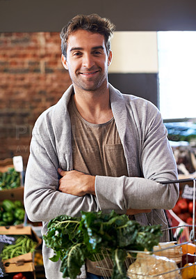Buy stock photo Portrait, basket or happy man shopping in supermarket for grocery promotions, sale or discounts deal. Arms crossed, smile or customer buying groceries for healthy food, organic vegetables or spinach