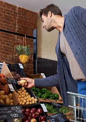 Buy stock photo Potato, food and man shopping at a supermarket for grocery promotions, sale or discounts deal. Check, fresh or customer buying groceries for healthy nutrition, organic vegetables or diet with choice
