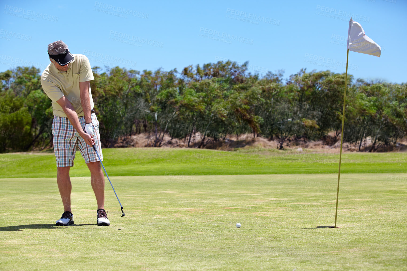 Buy stock photo Sport, man and golf on grass outdoor for playing, performance and game with fitness and wellness. Athlete, mature person and golfer with club, ball and exercise on field for recreation, hobby and fun