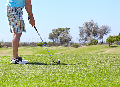 Buy stock photo Man, golf club and ball on green grass, field or lawn for sports, shot or ready to strike on course. Closeup of male person, golfer or player legs in stance with stick for score or point in nature