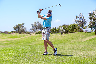 Buy stock photo A mature man playing a golf shot on the golf course