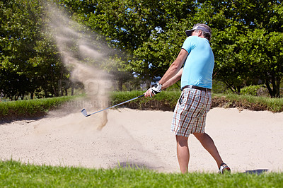 Buy stock photo Golf, sport and a man on course for training, professional game or a hobby in retirement. Sand, summer and an elderly player hitting a ball with a club for sports, golfing and recreation as a senior