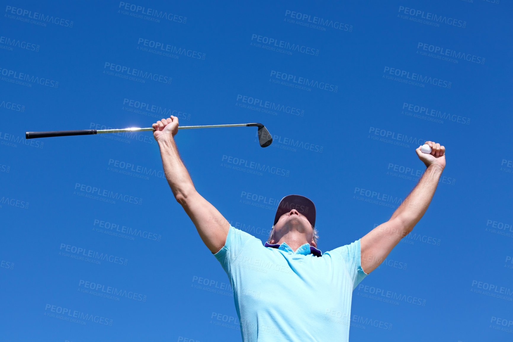 Buy stock photo Low-angle shot of a mature male golfer with his arms raised in celebration