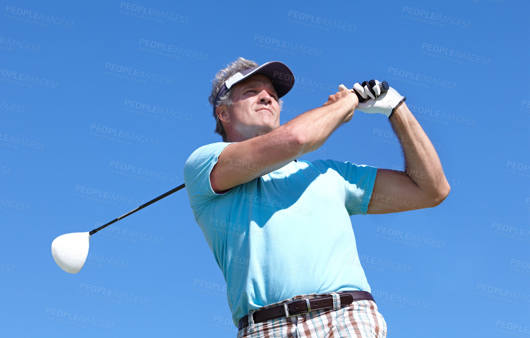 Buy stock photo Golf, swing and elderly man with driver outdoor for training, hobby and sports on blue sky background. Club, swinging and active senior male golfer on field for retirement fitness, match or practice