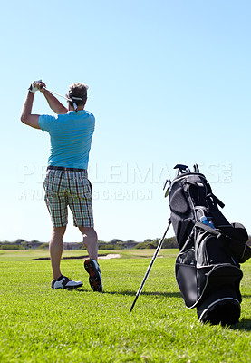 Buy stock photo Swing, golf and behind man with driver on a field for training, hobby and sports on blue sky background. Club, swinging and rear view of male golfer on field for fitness, match or sports practice