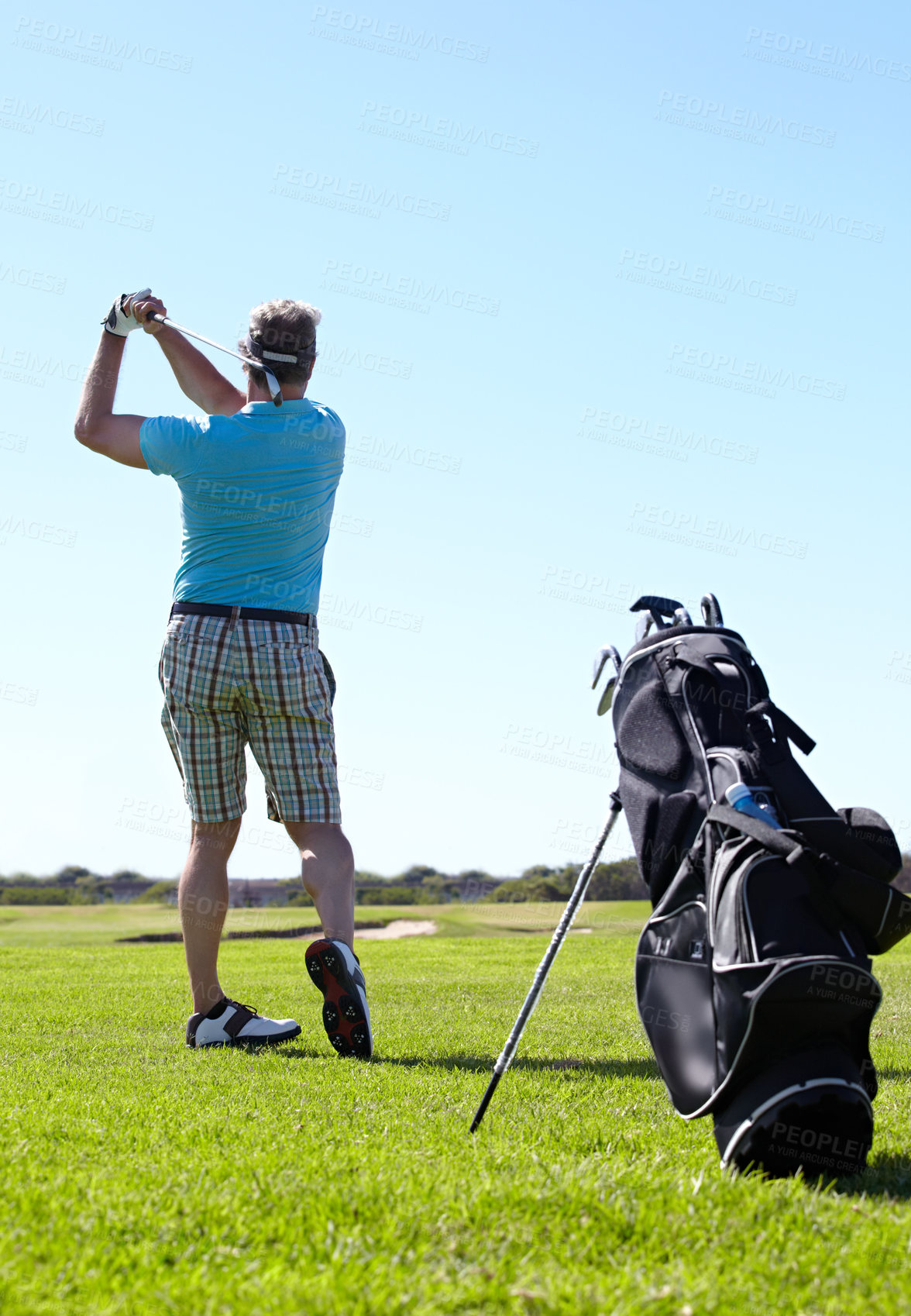 Buy stock photo Swing, golf and behind man with driver on a field for training, hobby and sports on blue sky background. Club, swinging and rear view of male golfer on field for fitness, match or sports practice