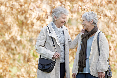 Buy stock photo Senior friends, happy and conversation in park by autumn leaves, together and bonding in retirement in outdoor. Elderly women, smile or communication on vacation in england, care or travel in nature