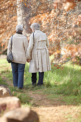Buy stock photo Rear view of two aging senior women out for a walk together