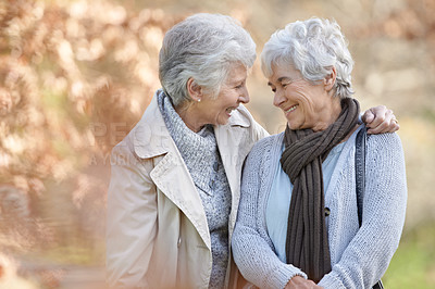 Buy stock photo Senior women, happy and support in park by autumn leaves, together and bonding on retirement in outdoor. Elderly friends, hugging or communication on vacation in england, smile or social in nature