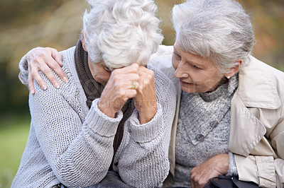 Buy stock photo A senior woman consoling her friend as they sit outdoors