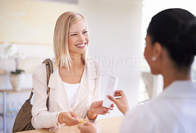 Buy stock photo Happy, shopping and woman buying a skincare product by a sales consultant by the desk in store. Smile, credit card and female person paying for health, self care and beauty treatment at natural shop.