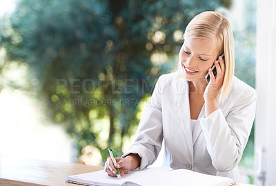 Buy stock photo Phone call, receptionist and woman writing notes at reception, talking or speaking to contact. Smile, notebook and female secretary with cellphone for schedule, appointment and booking at hotel.