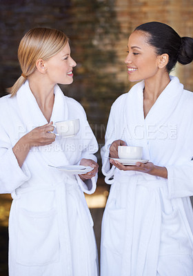 Buy stock photo Spa, friends and women drinking coffee for health, wellness and luxury skincare treatment for body. Girls, tea cup and  happy people in salon together for beauty in bathrobe, relax and diversity