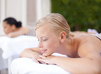 Buy stock photo Spa, woman and relax on massage bed with smile for wellness, zen and beauty treatment for body care. Person, sleeping and physical therapy at resort, salon table and luxury on holiday or vacation