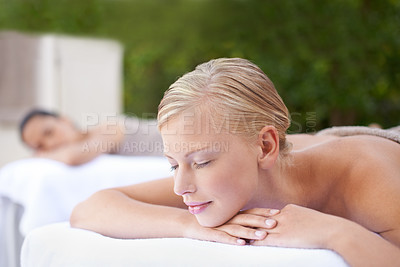 Buy stock photo Spa, woman and relax on massage bed with smile for wellness, zen and beauty treatment for body care. Person, sleeping and physical therapy at resort, salon table and luxury on holiday or vacation