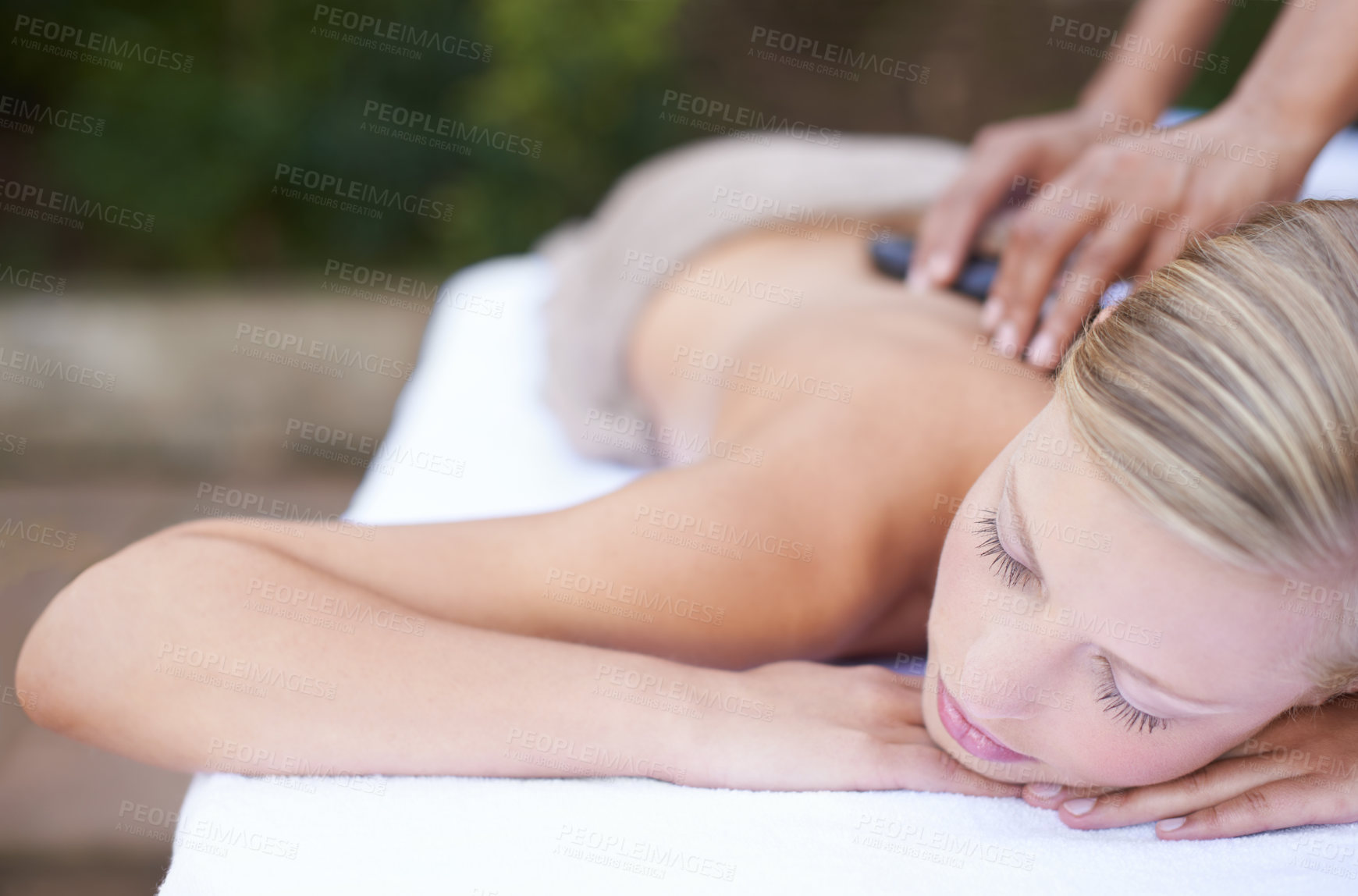 Buy stock photo Woman, massage and hot stones to relax, back and spa for treatment and stress relief therapy. Sleeping, masseuse and wellness in resort, peaceful and hands for luxury bodycare and tranquility