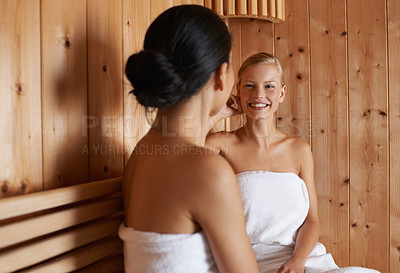 Buy stock photo Two friends relaxing in the sauna together