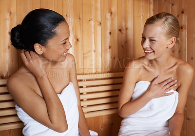 Buy stock photo Women, relax and talking in sauna at spa with healthy detox of sweat for beauty, wellness and skincare. Friends, treatment and sitting in steam room with a smile for anti aging benefits to body