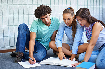 Buy stock photo Cropped view of college students studying together for their finals