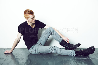 Buy stock photo A red haired man in stylish alternative attire sitting on a floor