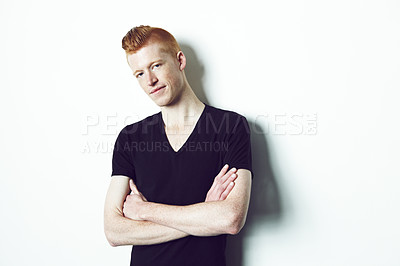 Buy stock photo A red haired male crossing his arms while looking at the camera against a white background