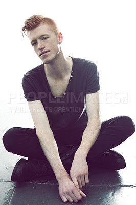 Buy stock photo A young man with a red mohawk posing in a black t-shirt and skinny jeans