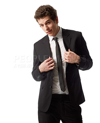 Buy stock photo A young man wearing a suit and tie standing in front of a white background