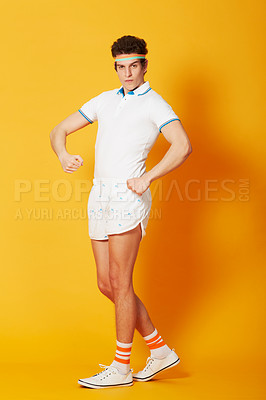 Buy stock photo Portrait, man and funny retro sports pose in vintage, fashion and 80s style isolated in yellow studio background. Athlete, tennis and workout or strong arms, crazy and comedy or exercise joke 