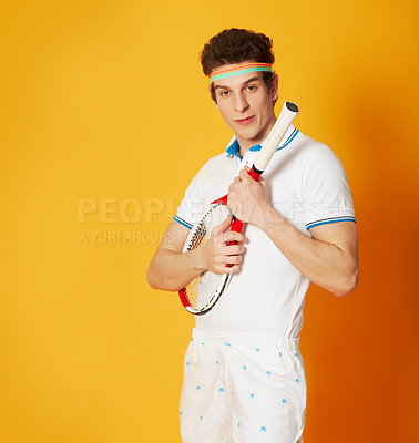 Buy stock photo A young man in a retro tennis outfit holding his racket like a quitar