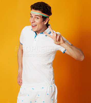 Buy stock photo Portrait, tennis and man with peace sign, smile and confident guy on a yellow studio background. Person, athlete and model with v gesture and symbol with feedback and fitness with wellness or player