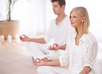 Buy stock photo Two people sitting in the lotus position in a yoga studio