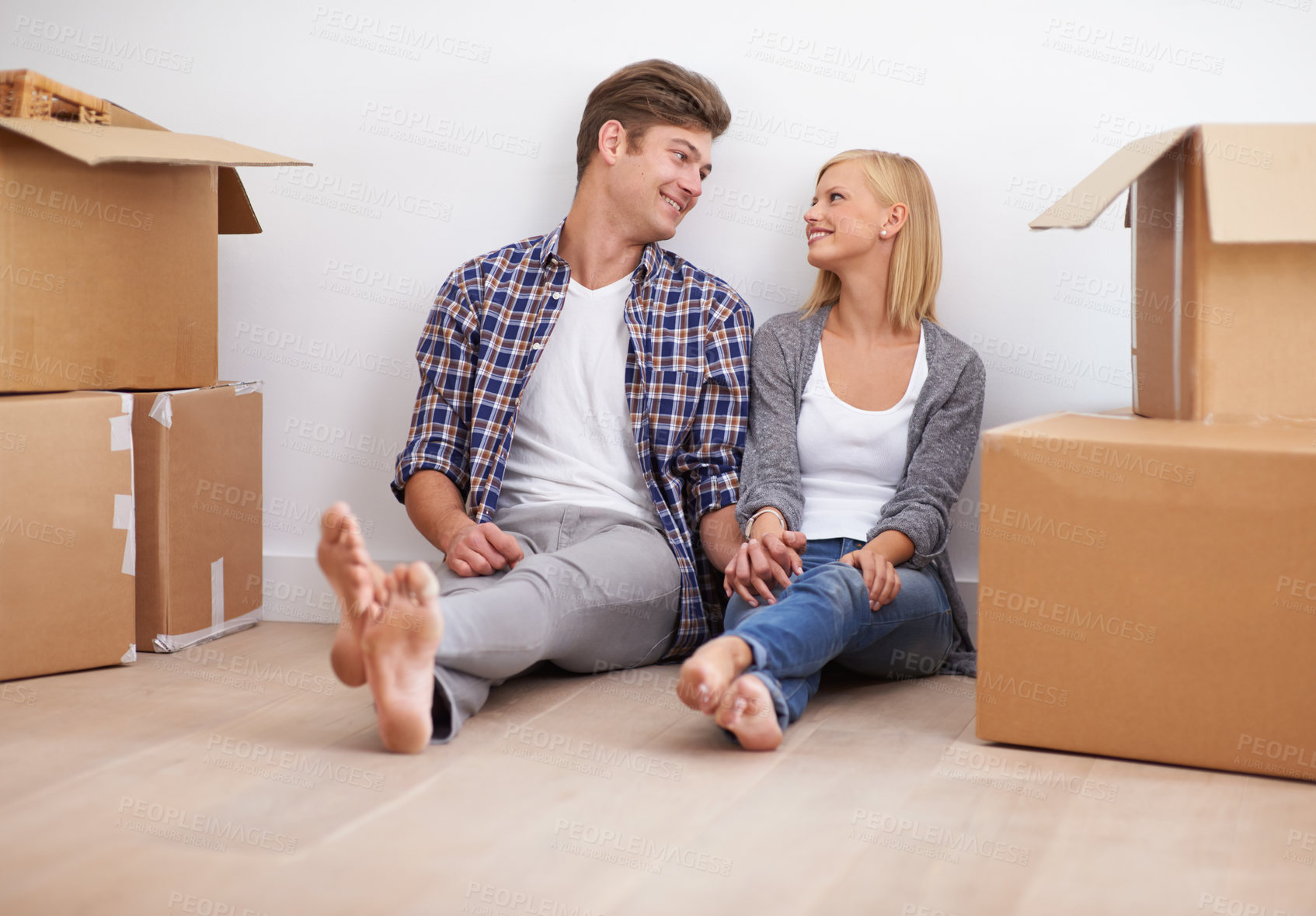 Buy stock photo Couple, moving and new home with boxes for packing, real estate and happy holding hands for support. Property, achievement or investment with people and cardboard for relocation, mortgage or rent