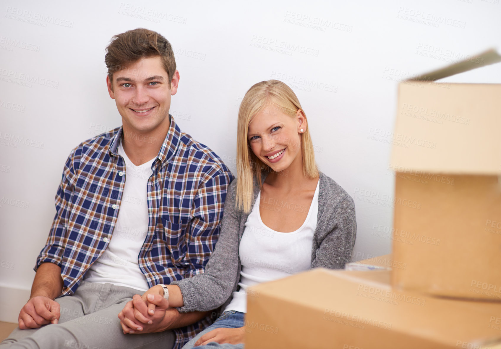 Buy stock photo Couple, moving and new home, portrait with boxes for packing and real estate, happy holding hands and support. Property, investment and people smile with cardboard for relocation, mortgage or rent