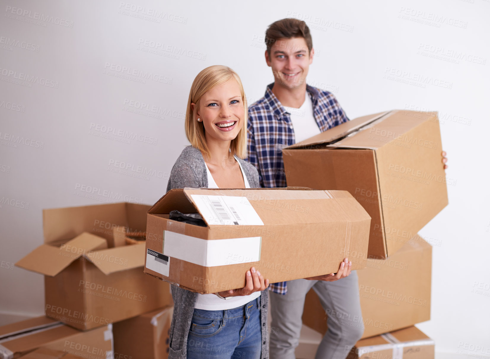 Buy stock photo Shot of a happy young couple on their moving in day