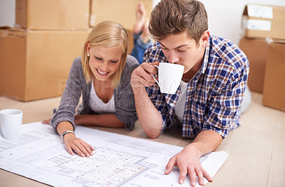 Buy stock photo Couple, floor plan and blueprints with moving boxes for renovation, new home or property investment. Man, woman and happy thinking or development for real estate design for mortgage, buy or coffee