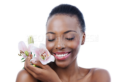 Buy stock photo Black woman, flower and smile for natural beauty, dermatology and skincare for glow and wellness on white background. Nature, skin and sustainable cosmetics, face with shine and orchid in a studio
