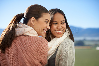 Buy stock photo Two young women standing outside smiling happily