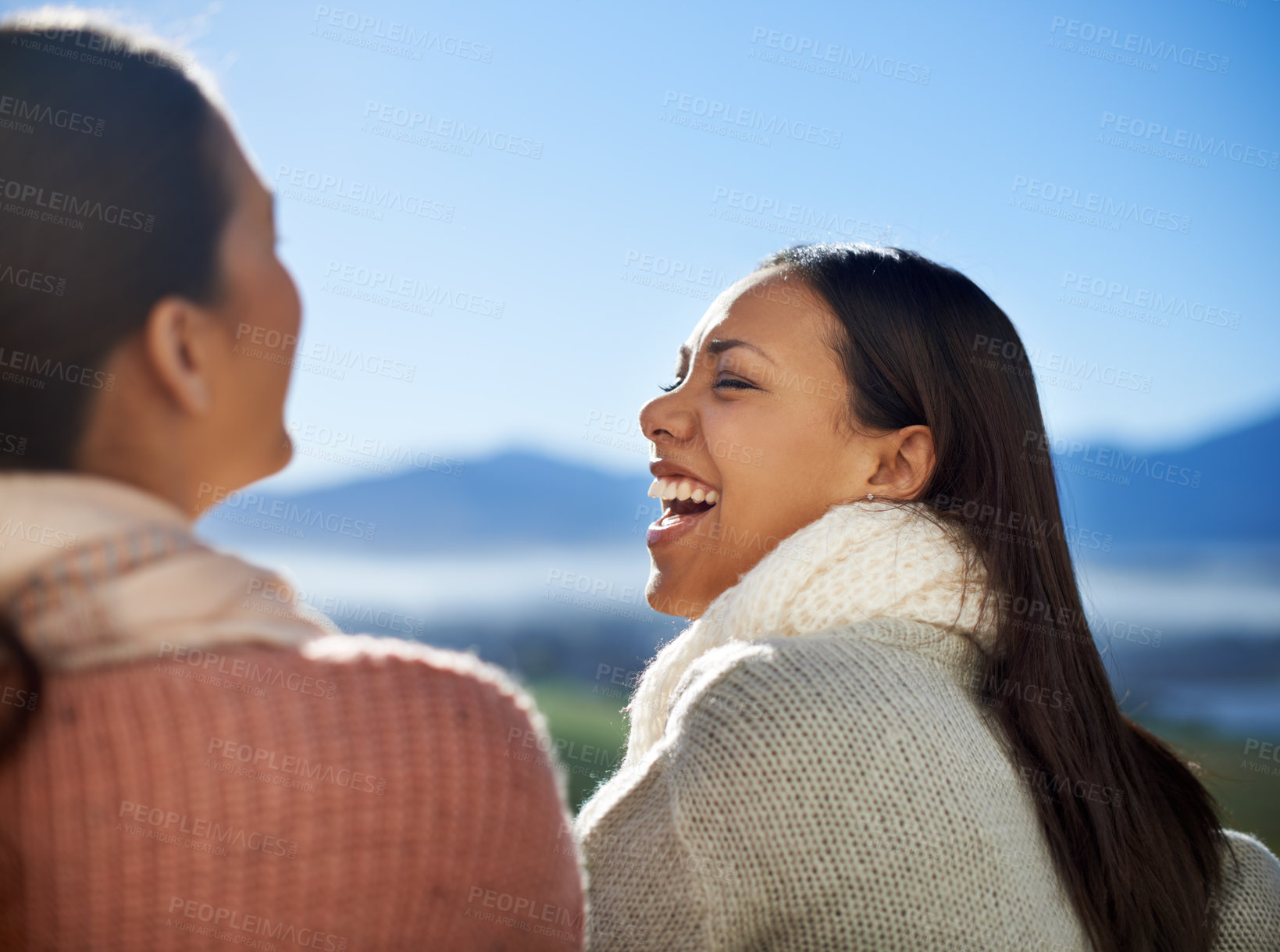 Buy stock photo Friends, women and laughing outdoor with blue sky for bonding, funny joke and care in nature with holiday. Rear view, people and happy on vacation or travel in winter with relax, break and enjoyment