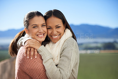 Buy stock photo Two young female friends standing happily in the outdoors
