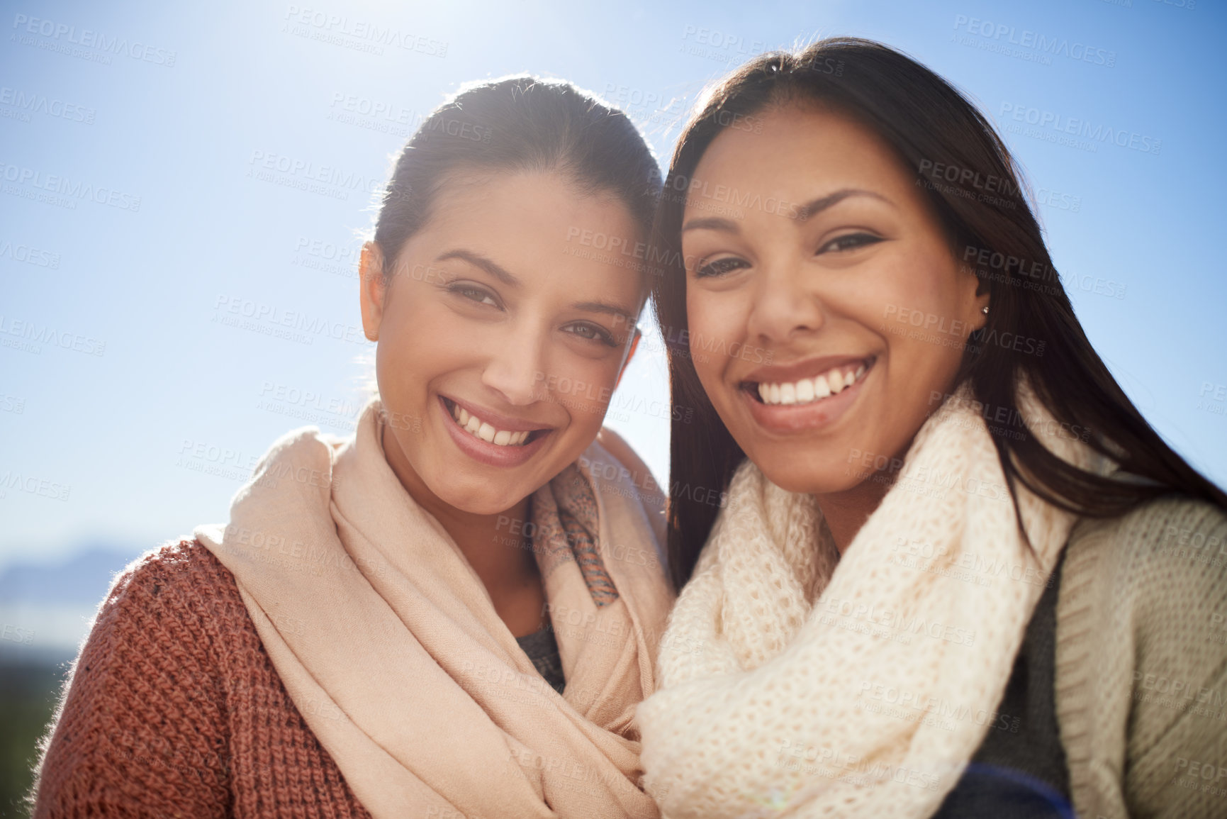 Buy stock photo Two young women smiling happily at the camera