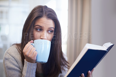 Buy stock photo Woman, drinking coffee and reading book for knowledge at home, literature and fiction novel for relaxation. Female person, tea and information for learning, comfortable and fantasy story on weekend
